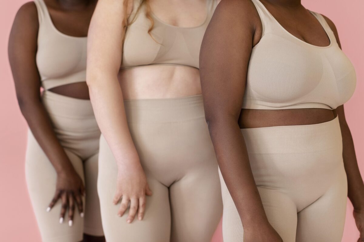 three-women-posing-while-wearing-body-shapewear